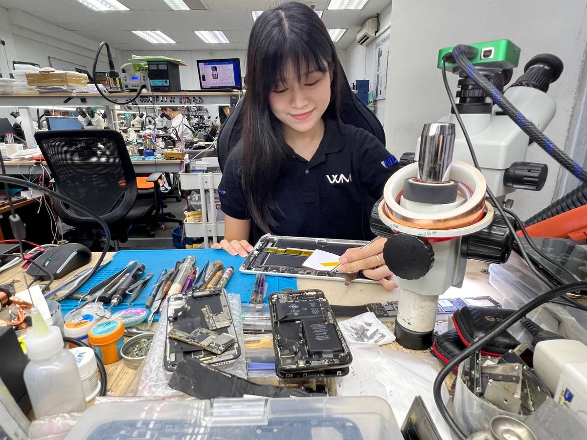 Tan Qin Xuan working at the repair bench